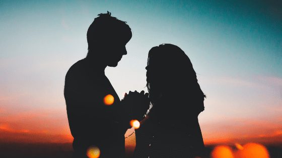 A couple holding each other's hands