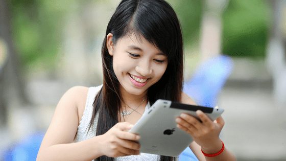A filipino woman chatting using tablet