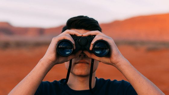 A man using binoculars